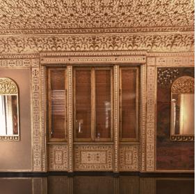 A wall of the Mirrors' Room with a closed window