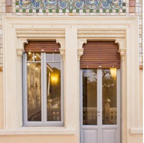 Doorway to the terrace, with a door and a window decorated by Galileo Chini